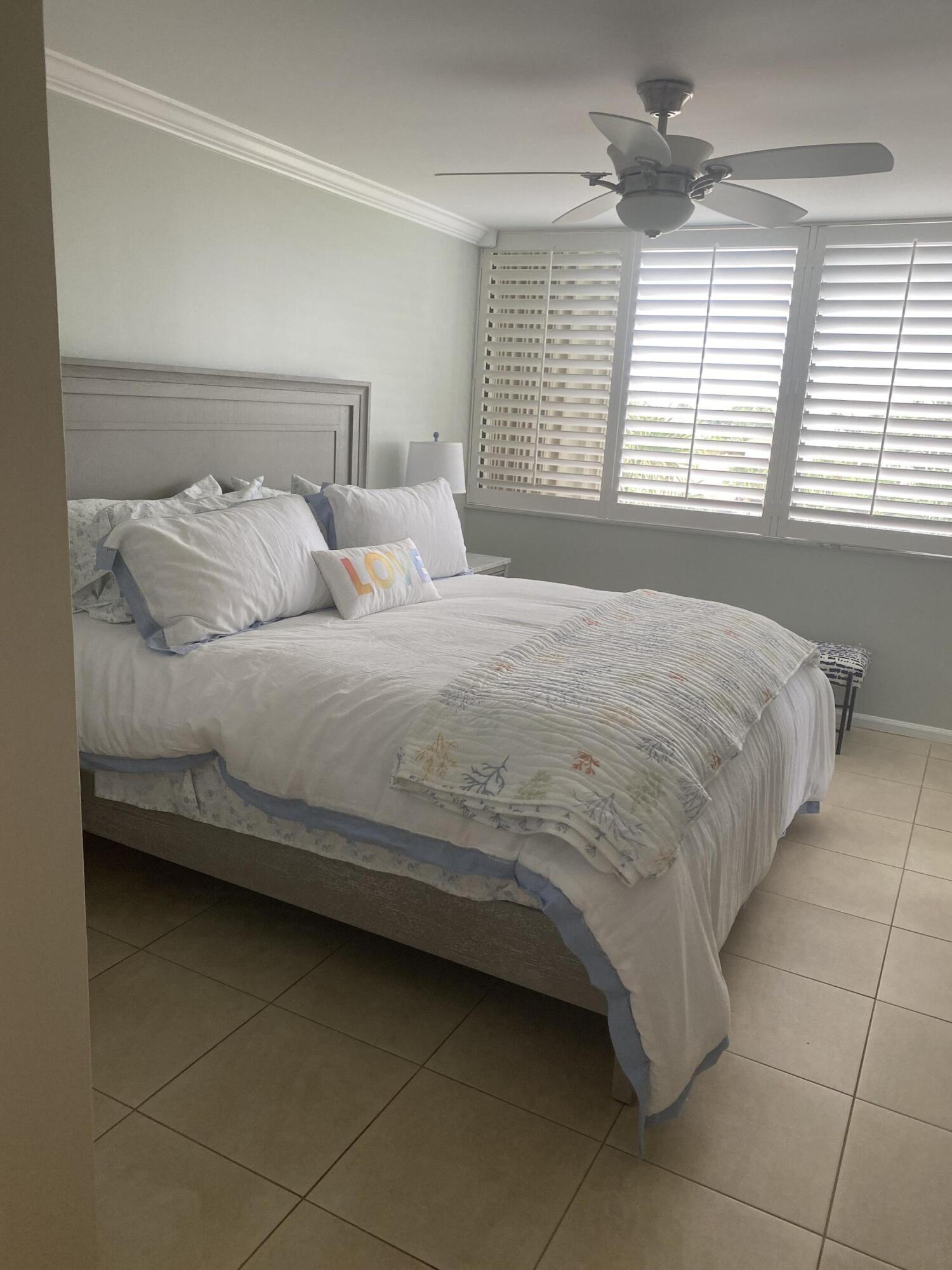 1605 Highway 1, Unit 401M3 Jupiter, FL 33477 - Photo 7 of 28 a bedroom with a bed and a window