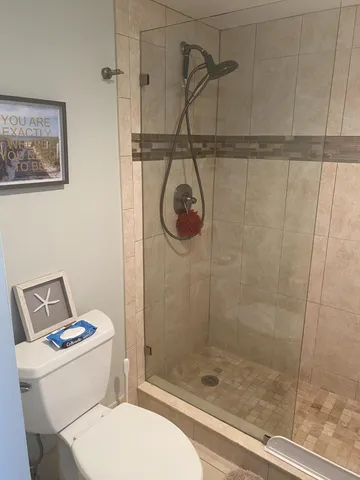 a bathroom with a toilet and a shower