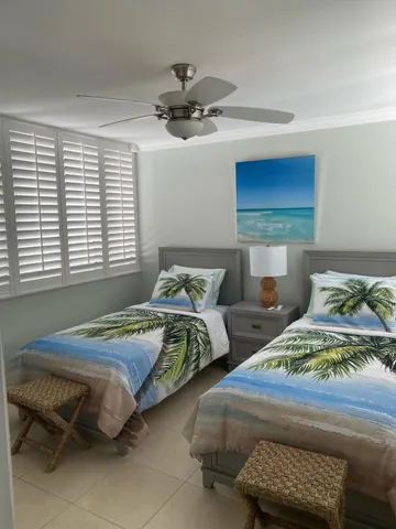 a bedroom with two beds and a window