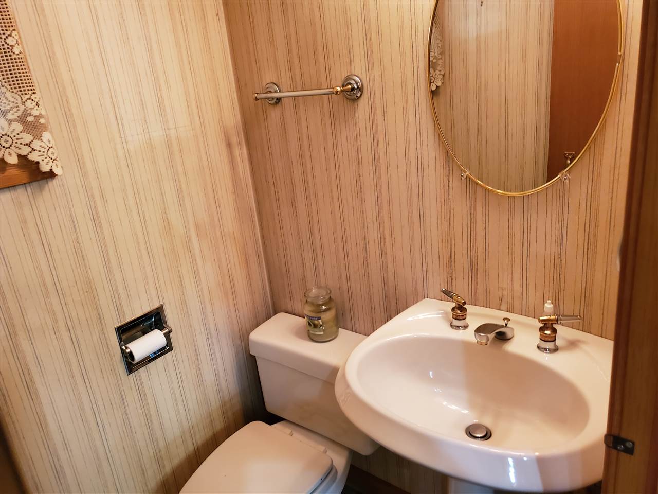 3514 North River Road Oregon, IL 61061 - Photo 6 of 25 a bathroom with a sink a toilet and a mirror