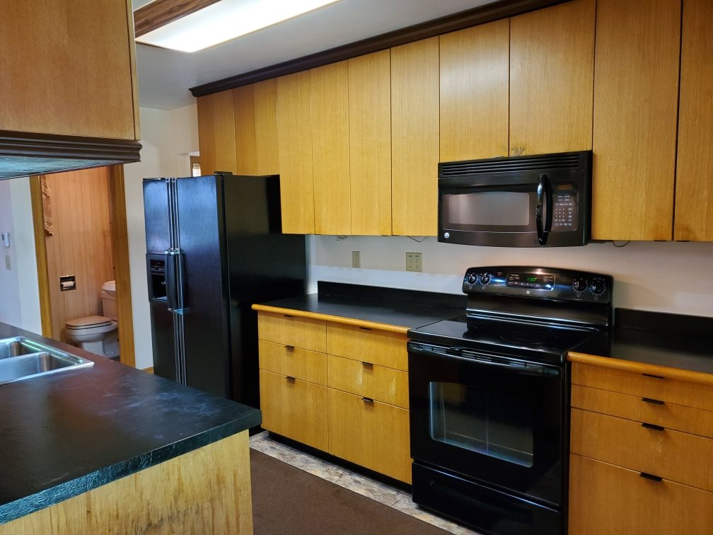 3514 North River Road Oregon, IL 61061 - Photo 9 of 25 a kitchen with a stove microwave and refrigerator