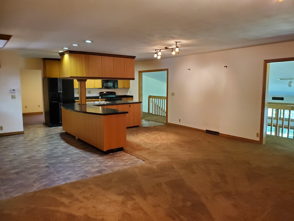 3514 North River Road Oregon, IL 61061 - Photo 10 of 25 a kitchen with stainless steel appliances granite countertop a stove and a sink