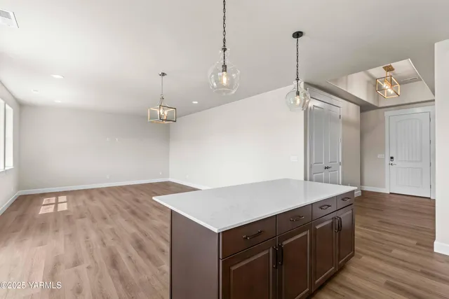 a kitchen with a wooden floor and window