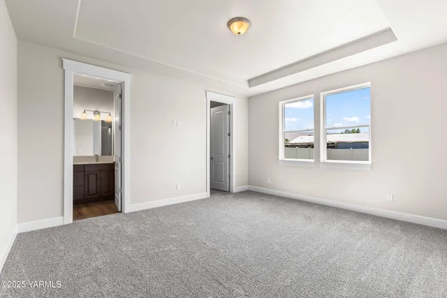 an empty room with windows and cabinet