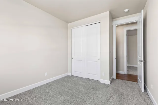 an empty room with closet area