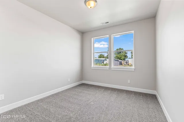 an empty room with windows and entrance