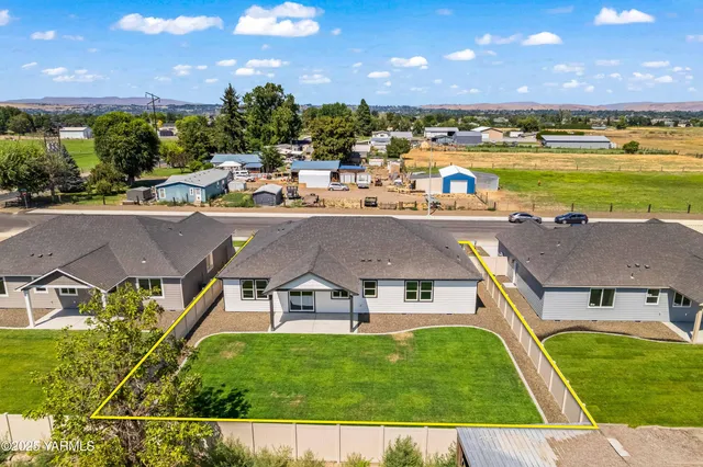 an aerial view of a house with swimming pool and outdoor space