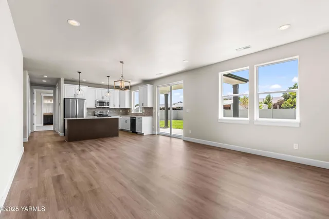 a view of a kitchen with furniture and wooden floor