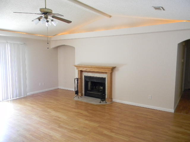 2844 Old Mill Way Crestview, FL 32539 - Photo 11 of 49 a view of empty room with a fireplace and wooden floor