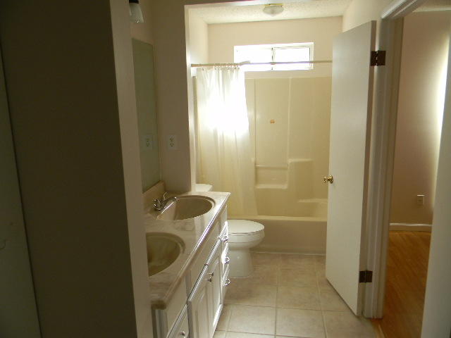 2844 Old Mill Way Crestview, FL 32539 - Photo 27 of 49 a bathroom with a granite countertop sink a toilet a mirror and shower