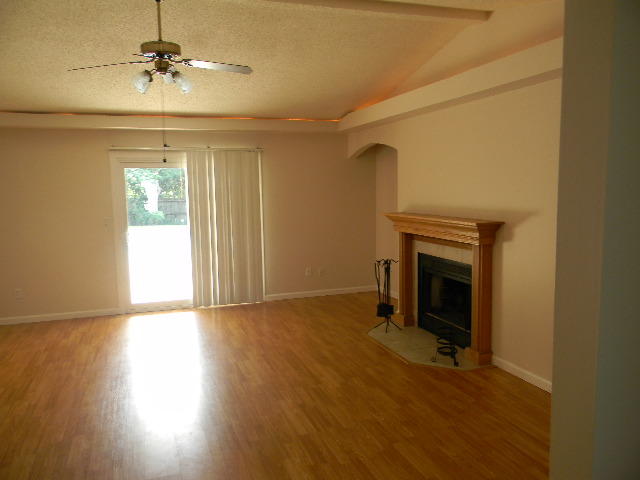 2844 Old Mill Way Crestview, FL 32539 - Photo 7 of 49 a view of empty room with a fireplace and wooden floor