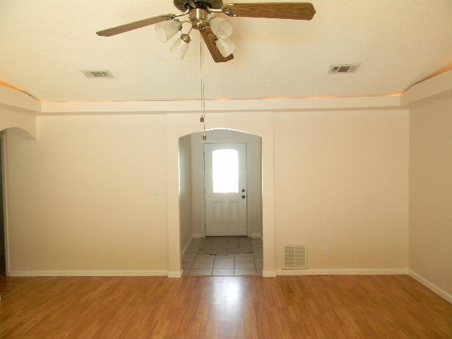 2844 Old Mill Way Crestview, FL 32539 - Photo 9 of 49 a view of an empty room with a window and wooden floor