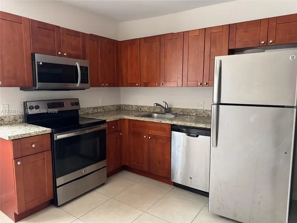a kitchen with a refrigerator stove and microwave
