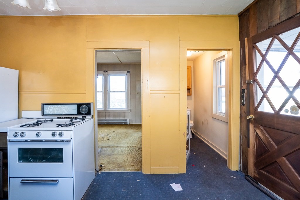 2049 Pleasant Street Three Rivers, MA 01080 - Photo 11 of 19 a kitchen with a stove and a white refrigerator