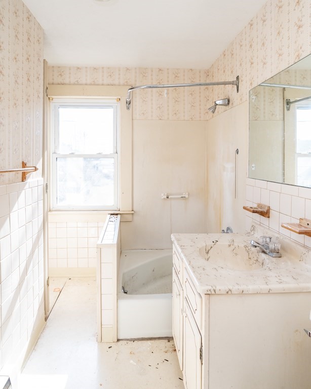 2049 Pleasant Street Three Rivers, MA 01080 - Photo 19 of 19 a bathroom with a granite countertop sink a shower and a mirror