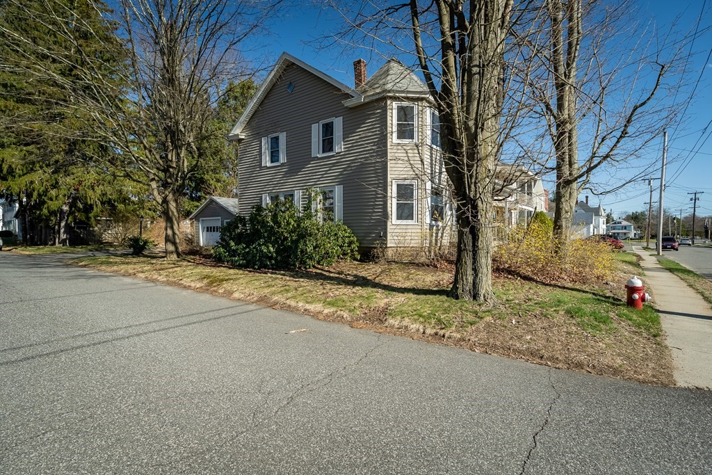 2049 Pleasant Street Three Rivers, MA 01080 - Photo 3 of 19 a front view of a house with a yard and garage