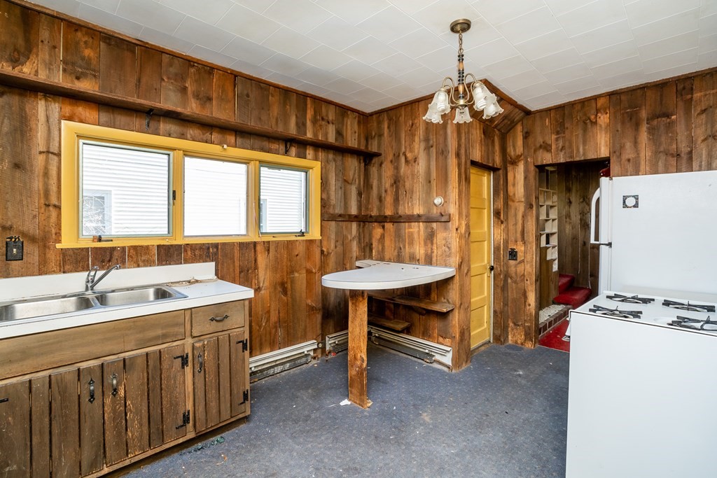 2049 Pleasant Street Three Rivers, MA 01080 - Photo 9 of 19 a kitchen that has a lot of cabinets in it and wooden floors