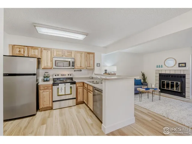 a kitchen with a refrigerator stove top oven and cabinets