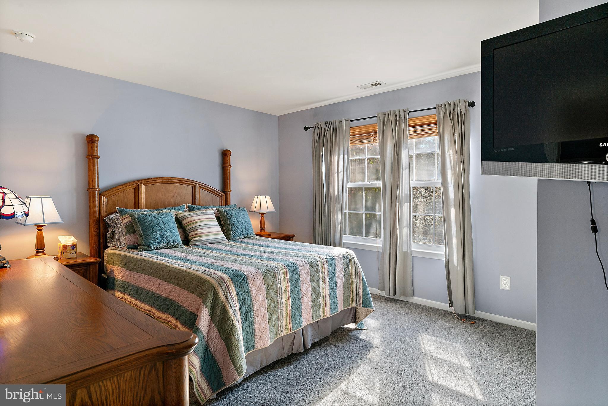 4 Midfield Street Sicklerville, NJ 08081 - Photo 24 of 40 a bedroom with a bed and a flat tv screen on dresser