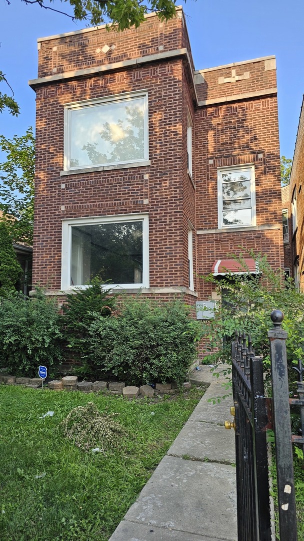 7839 South Loomis Boulevard, Unit 1 Chicago, IL 60620 - Photo 1 of 10 a front view of a house with a yard
