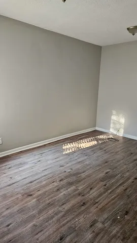 a view of room with wooden floor