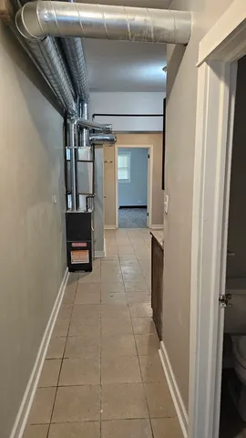 a view of hallway with stairs and a couch