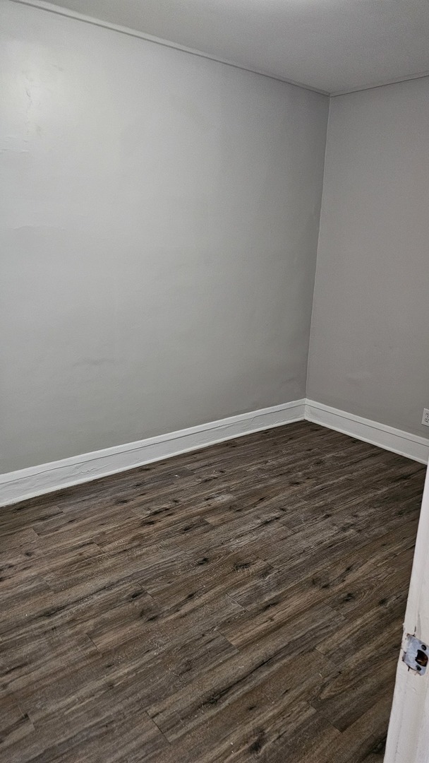 7839 South Loomis Boulevard, Unit 1 Chicago, IL 60620 - Photo 10 of 10 a view of an empty room with wooden floor
