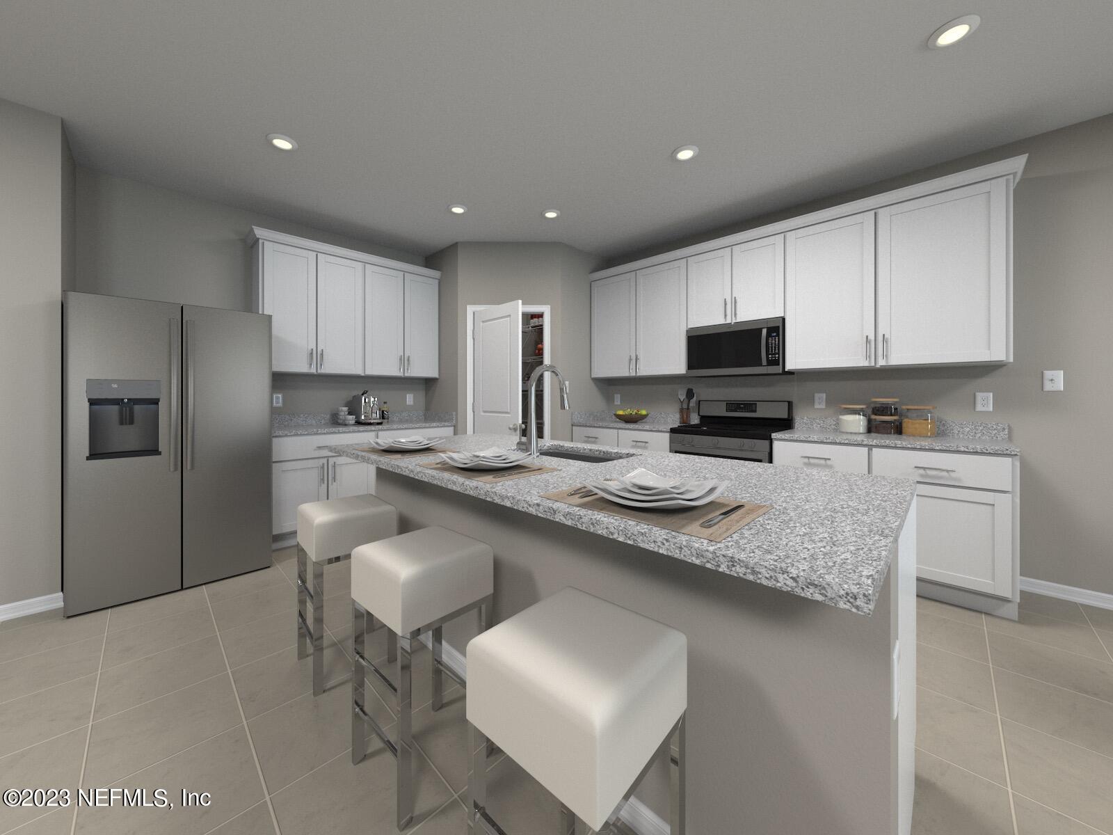 a kitchen with kitchen island granite countertop a sink a counter top space stainless steel appliances and cabinets