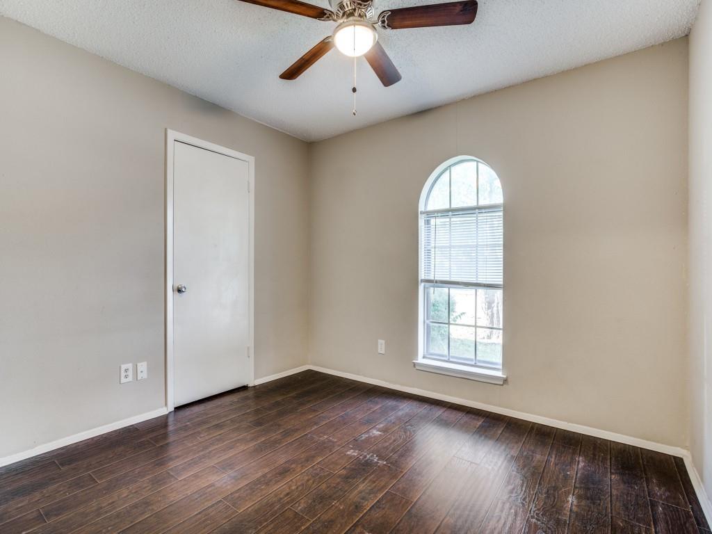 301 Springwillow Road Burleson, TX 76028 - Photo 11 of 12 Unfurnished room featuring a textured ceiling, dark wood-style flooring, and ceiling fan