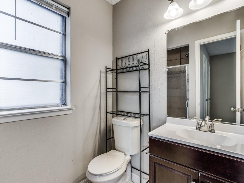 301 Springwillow Road Burleson, TX 76028 - Photo 8 of 12 Full bathroom with a textured wall, a shower stall, and vanity