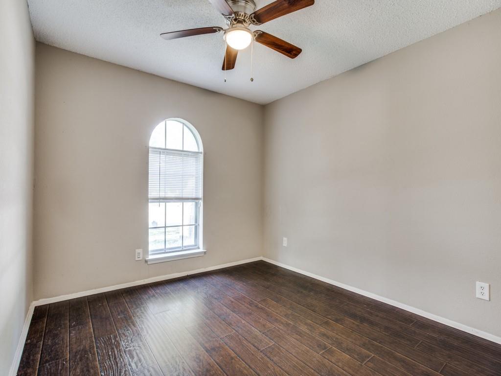 301 Springwillow Road Burleson, TX 76028 - Photo 9 of 12 Spare room with dark wood-type flooring, a textured ceiling, and a ceiling fan