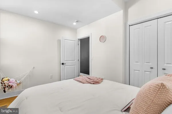 a bedroom with a bed and a mirror