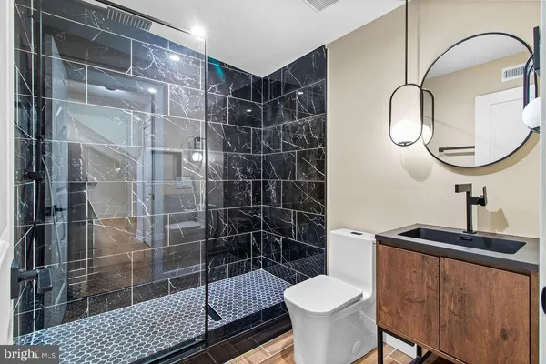 a bathroom with a sink toilet and shower