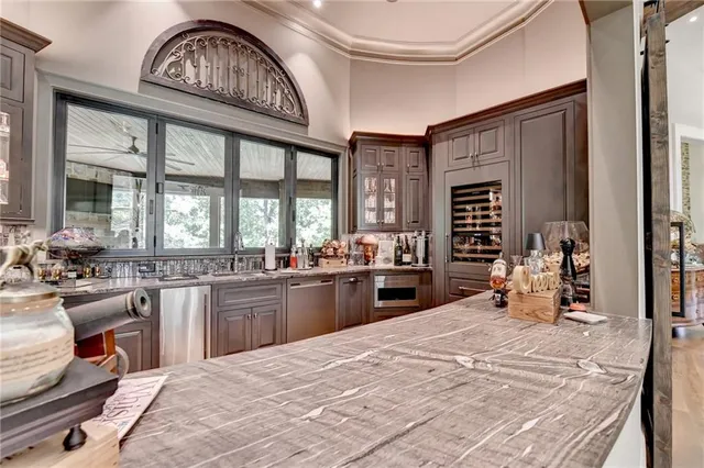 a bathroom with a granite countertop tub sink and mirror