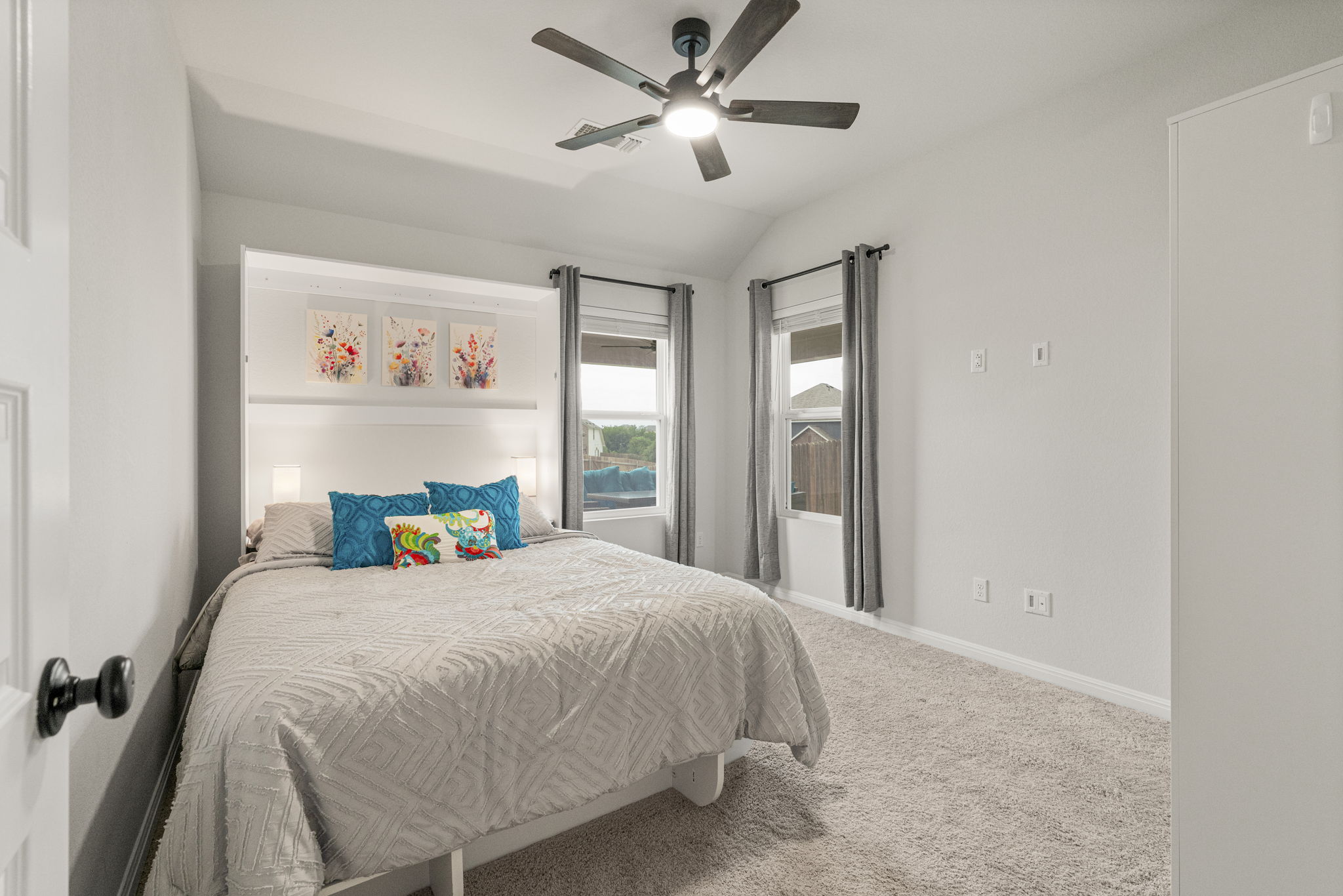 19412 Forman Drive Pflugerville, TX 78660 - Photo 22 of 34 The secondary bedrooms offer comfortable layouts with soft carpeting and ceiling fans for added comfort. Murphy bed to convey.
