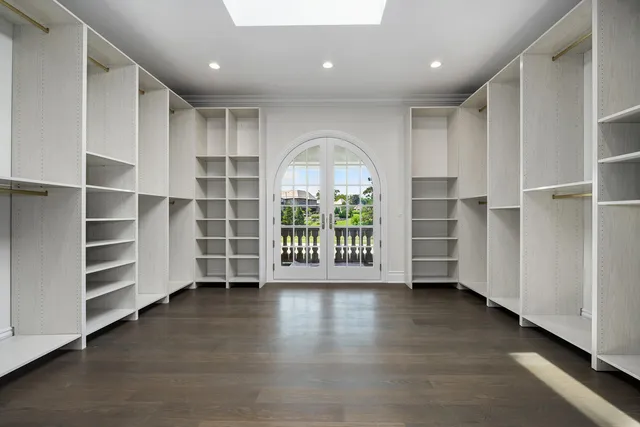 a view of a hallway view with wooden floor and a fireplace