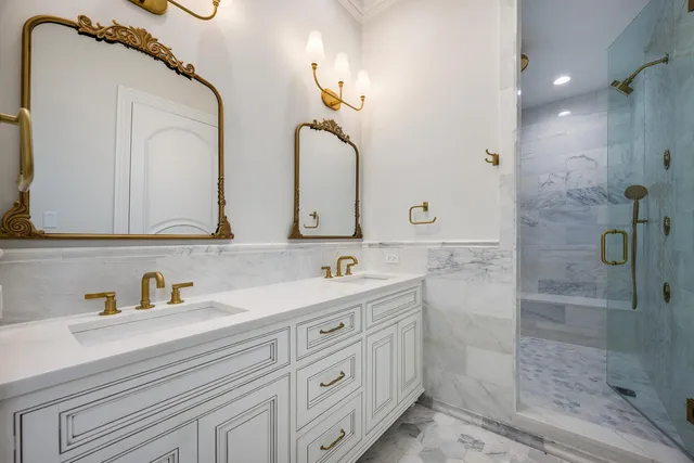 a kitchen with white cabinets and sink