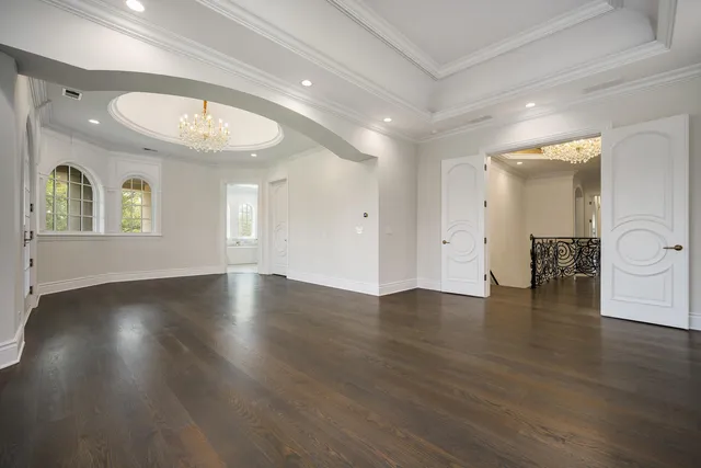 a view of a house with a cars park side of a road