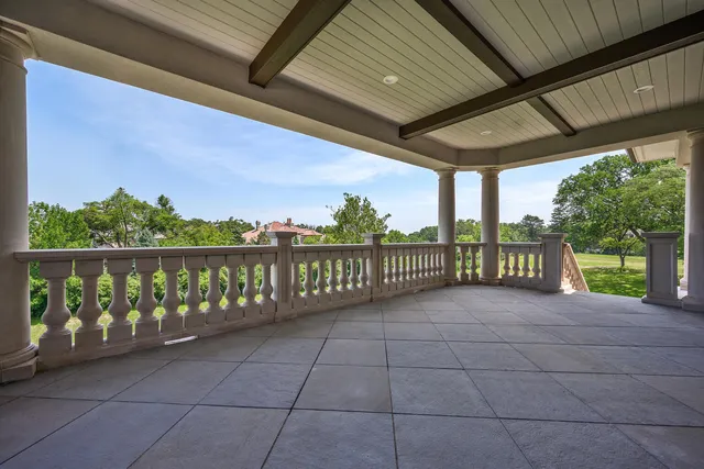 an aerial view of a house with a garden and swimming pool