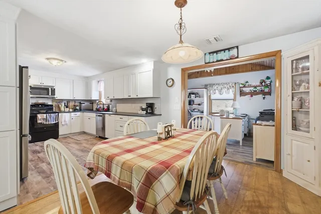 a large kitchen with a table and chairs