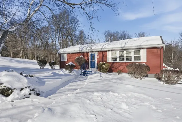 a view of a house with snow on the road