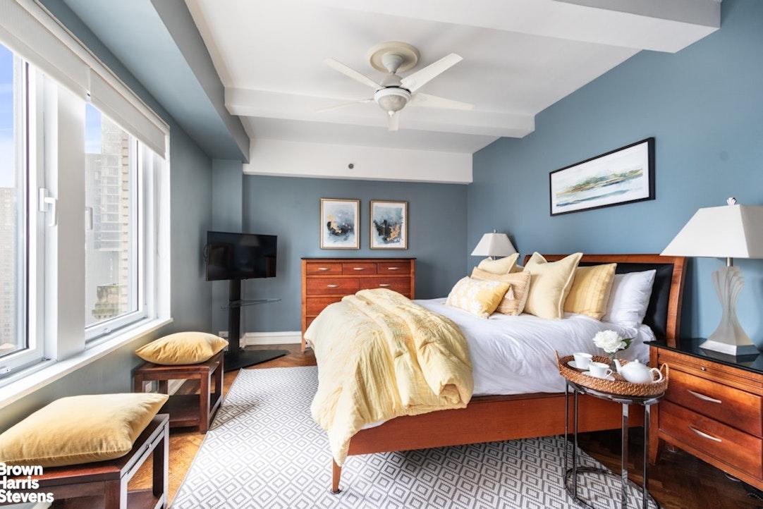 a bedroom with a bed and a chandelier