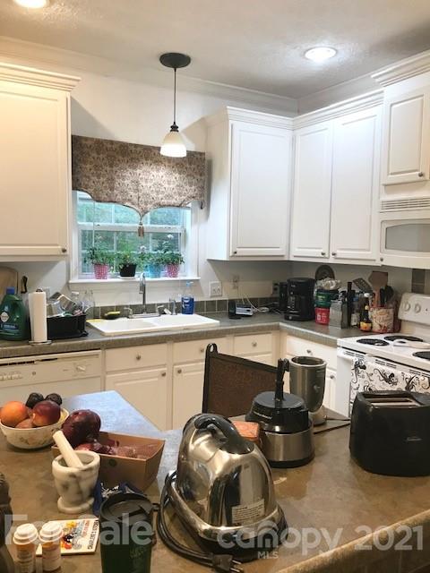352 Pamela Road York, SC 29745 - Photo 8 of 21 a kitchen with a sink a stove and a chandelier