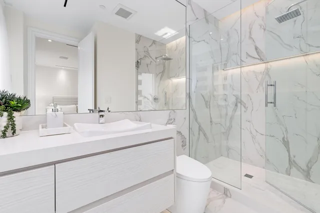 a view of swimming pool with outdoor seating and plants in the background