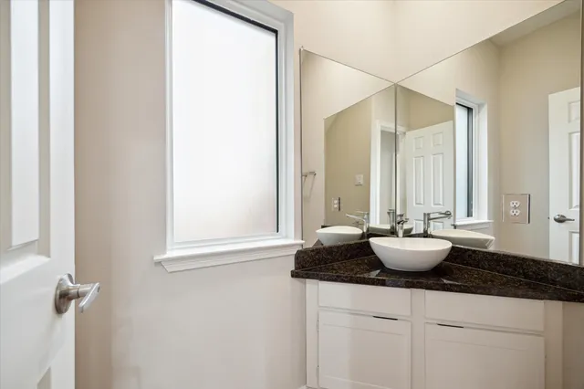 a bathroom with sink and window