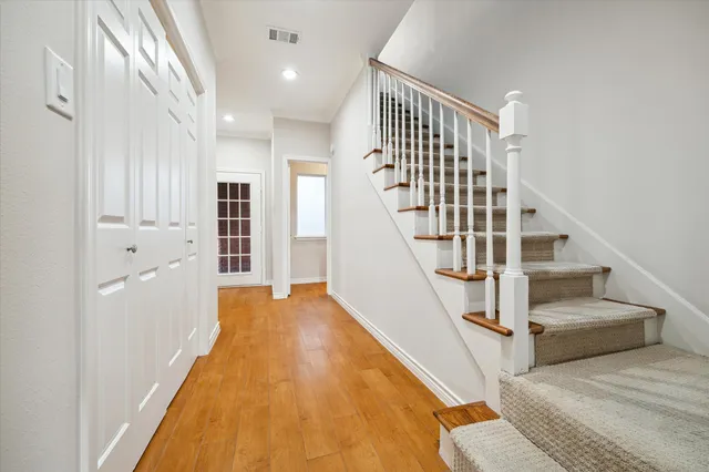a view of entryway and hall with wooden floor