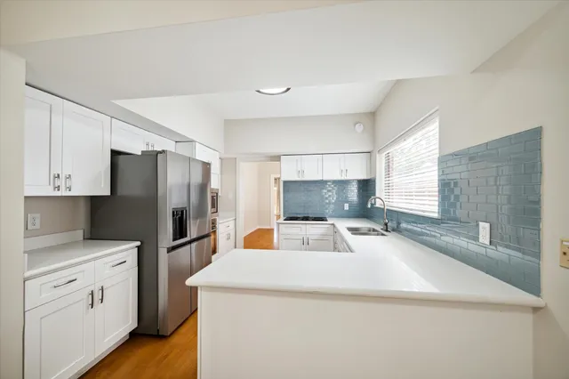 a kitchen with stainless steel appliances a refrigerator sink and cabinets