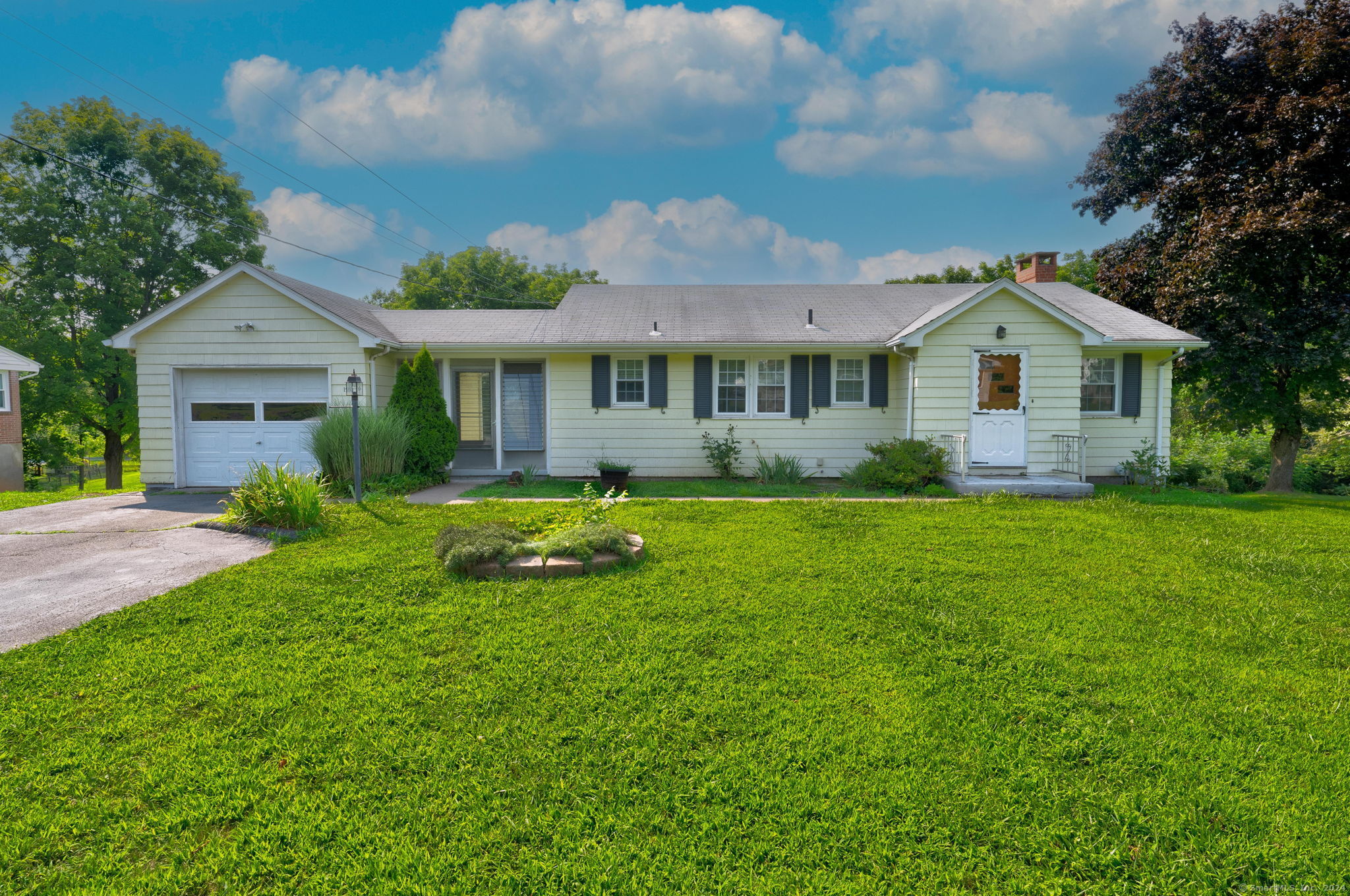 a front view of house with yard and green space