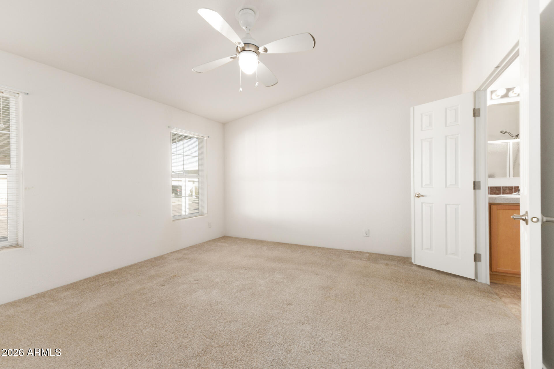 16101 North El Mirage Road, Unit 429 El Mirage, AZ 85335 - Photo 9 of 31 an empty room with windows and fan