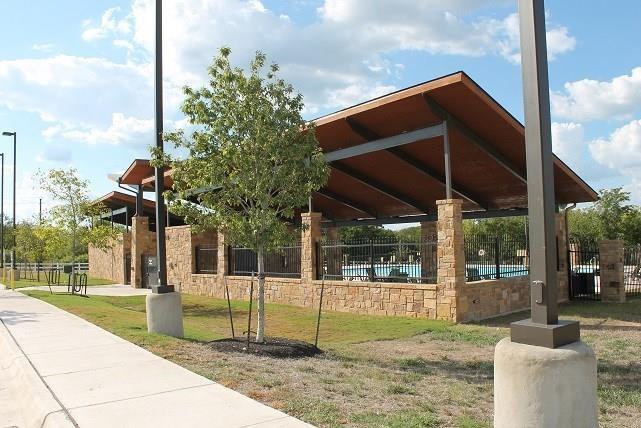 5716 Southerner Way Austin, TX 78747 - Photo 30 of 33 A community recreation area showcases a contemporary stone pavilion next to a sparkling pool.